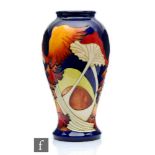 A boxed Moorcroft Pottery vase decorated in the Parasol Dance pattern designed by Kerry Goodwin,