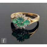 A 9ct hallmarked emerald and diamond cluster ring, four oval emeralds within a part border of