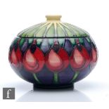 A Moorcroft Pottery powder bowl and cover decorated in the April Tulip pattern designed by Emma