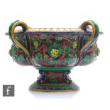 A large late 19th Century majolica quatre-lobed wine cooler decorated with moulded grape vines in