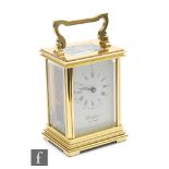 A 20th Century brass carriage clock, the white dial signed Woodford, height 12cm.