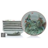 A set of eight Chinese famille verte dishes, each of circular form, the shallow well of each
