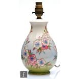 A Moorcroft Pottery table lamp decorated in the Apple Blossom pattern designed by Sally Tuffin,