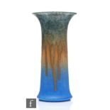 A Ruskin Pottery crystalline glaze lily vase in green to orange to blue, impressed mark and dated