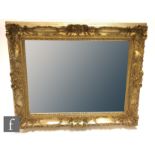 A Victorian style gilt framed bevelled edge mirror with acanthus and C scroll frame, 103cm x 80cm.
