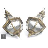A pair of Victorian style brass hanging lanterns, each of teardrop form, the cast brass floral