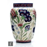 A Zsolnay Pecs barrel vase decorated in the Persian style with tulip and carnations in tones of