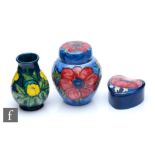 Three small pieces of Moorcroft comprising a vase decorated in the Buttercup pattern designed by