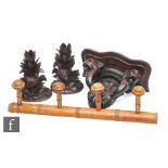 A pair of late 19th to early 20th Century carved Black Forest candlesticks or spill holders, each