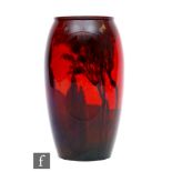 A Royal Doulton Flambe vase decorated in the round with a tree lined silhouette, printed mark