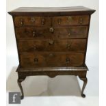 An 18th Century walnut feather banded chest of two short and three long drawers, later brass drop