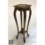 A late 19th to early 20th Century carved gilt jardiniere stand, the shaped top over slender legs