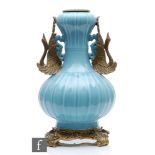 A Chinese Robin's Egg blue porcelain vase of bottle form, rising to a garlic head, applied with