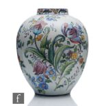 A post war Portuguese Carvalho pottery vase of swollen form decorated with hand painted tulips and