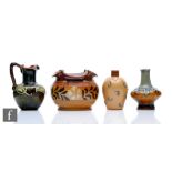 Four small pieces of Royal Doulton comprising two small vases, a jug and a cache pot, all with