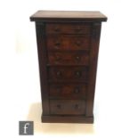 A Victorian mahogany Wellington chest of eight drawers, turned wood handles, over a plinth base,