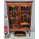 A 19th Century inlaid mahogany floorstanding display cabinet enclosed by a pair of fan paterae and