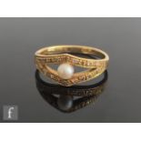 An 18ct cultured pearl and diamond ring central pearl to a diamond set split head, weight 4.2g, ring
