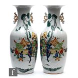 A pair of Chinese famille rose vases, each of ovoid form rising to a flared rim, flanked with