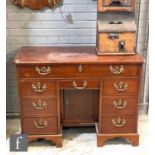 A George III mahogany knee hole desk, the moulded edge top opening to reveal a fitted interior and