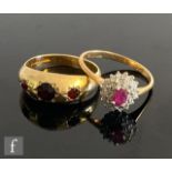 A 9ct hallmarked gypsy set garnet three stone ring, with a similar 9ct ruby and diamond cluster
