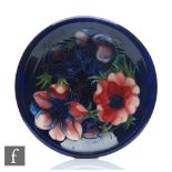 A Moorcroft plate decorated in the Anemone pattern, impressed mark and initialled in blue,