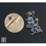 A contemporary hallmarked silver circular pendant/brooch set with a single amethyst, diameter 4.5cm,