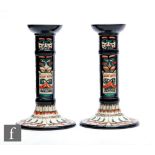 A pair of Moorcroft Pottery Collectors Club totem pole candlesticks decorated with tubelined motif