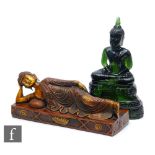 A Chinese green pressed moulded glass figure of Buddha, seated in dhyanasana atop a pedestal base,