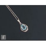 An 18ct white gold aquamarine and diamond pendant, central pea shaped claw set aquamarine above a