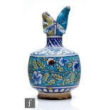 A late 19th to early 20th Century Persian vase decorated in the Iznik style with a band of flowers