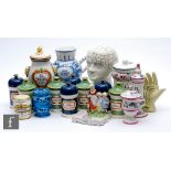 A collection of replica pharmaceutical jars and covers, some named, assorted colours including a