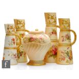 Four early 20th Century Royal Worcester blush ivory shape 1047 conical ewers each decorated with