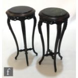 A pair of 20th Century stained and carved beech black and green marble inset jardinière stands,