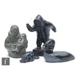 A group of four Boma carved ebonised figures, one of an Eskimo with a child, another figure standing