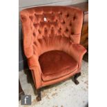 A George III style carved mahogany horseshoe back easy chair, on carved cabriole legs, upholstered