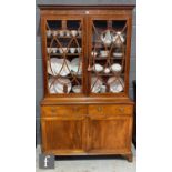 A 19th Century mahogany and line inlaid bookcase enclosed by a pair of swept bar glazed doors