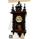 A late 19th Century walnut cased regulator wall clock, spring driven movement enclosed by a glazed