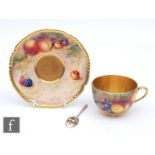 A Royal Worcester Fallen Fruits teacup and saucer decorated by Cook and Higgins with hand painted