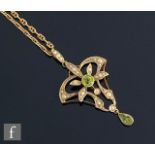 An Edwardian 9ct peridot and seed pearl open work pendant, length 5cm, suspended from a modern 9ct