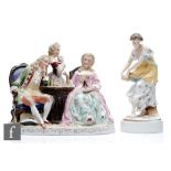 A 20th Century figural group modelled as a lady and gentleman playing chess with a maid in