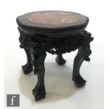 A Chinese Huanghuali style jardiniere stand, the lotus form upper top with rouge marble insert,