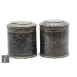 A pair of 19th Century Bidri spice canisters and covers, decorated with all over trailing leaves and