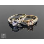 A 9ct white gold tanzanite and diamond ring, central oval claw set tanzanite to diamond set