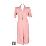 A 1940s ladies CC41 Utility vintage dress in pink heavy crepe with white polka dot pattern, with