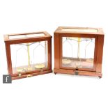 Two mahogany cased sets of balance scales. (2)