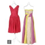 A 1950s ladies vintage dress in magenta satin with cross over V neck bodice to a pleated a line