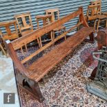 Two late 19th to early 20th Century pitch pine church pews, with open rail backs and end supports,