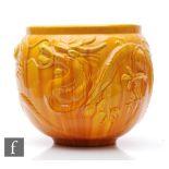 A large Chinese jardinere, the yellow glazed vessel relief moulded to the exterior with two