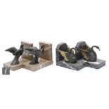 A pair of 20th Century bookends, decorated with stylised spelter doves, mounted to an L shape marble